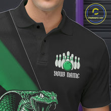 Load image into Gallery viewer, Left chest detail of a black bowling polo featuring a green cobra, bowling ball, and pin graphics.
