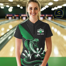 Load image into Gallery viewer, Female model in a bowling center wearing a black quarter-zip with green cobra artwork and bowling-themed accents.