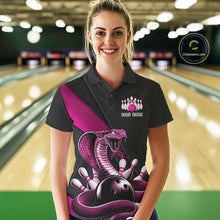 Load image into Gallery viewer, Female model wearing a black bowling polo in a bowling center with pink cobra artwork and bowling pin graphics.