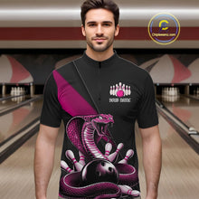 Load image into Gallery viewer, Male model at a bowling alley wearing a black quarter-zip with pink cobra artwork wrapped around a bowling ball.