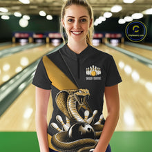 Load image into Gallery viewer, Female model in a bowling lane wearing a black quarter-zip decorated with yellow cobra artwork and bowling pin graphics.