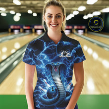 Load image into Gallery viewer, Female model wearing a bowling polo in a bowling alley with blue cobra graphics and a lightning background.