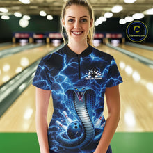 Load image into Gallery viewer, Female model wearing a bowling quarter-zip at the bowling lane with blue cobra graphics and lightning-inspired accents.