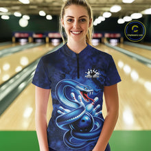 Load image into Gallery viewer, Female model wearing a bowling quarter-zip in a bowling lane with blue cobra artwork wrapped around a bowling ball and scattered pins.