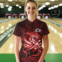 Load image into Gallery viewer, Female model at the bowling lane wearing a quarter-zip with red cobra artwork wrapped around a bowling ball.