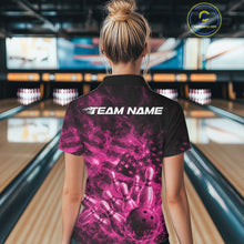 Load image into Gallery viewer, Back view of a womens black and pink bowling polo displaying a flaming bowling strike scene with flag-inspired details.