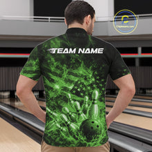 Load image into Gallery viewer, Front view of a mens black and green quarter-zip showcasing a bowling ball smashing through pins with flames and flag-inspired graphics.