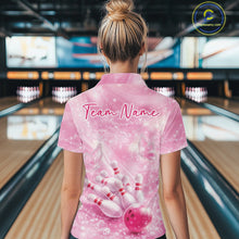 Load image into Gallery viewer, Back view of a female model at a bowling alley wearing a pink quarter zip shirt featuring bowling strike artwork with butterflies.