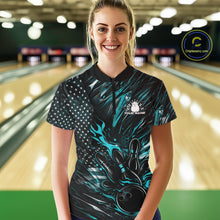 Load image into Gallery viewer, Female model in a bowling lane wearing black and turquoise blue quarter zip shirt, front view featuring patriotic flaming bowling ball hitting pins dynamic sports design