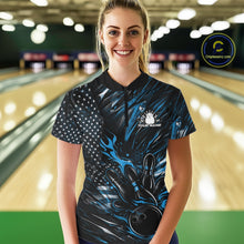 Load image into Gallery viewer, Female model in a bowling lane wearing black and blue quarter zip shirt, front view featuring patriotic flaming bowling ball knocking down pins illustration