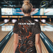 Load image into Gallery viewer, Back view of a female model in a bowling alley wearing a black and orange polo shirt featuring a flaming bowling ball and patriotic bowling motif.