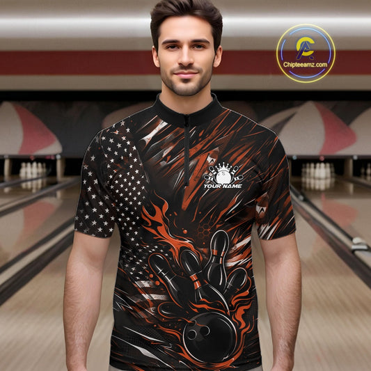 Male model wearing a black and orange bowling quarter-zip shirt at a bowling lane with fiery bowling strike artwork and patriotic styling.