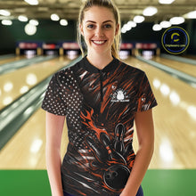 Load image into Gallery viewer, Female model in a bowling lane wearing black and orange quarter zip shirt, front view featuring patriotic flaming bowling ball hitting pins dynamic sports illustration