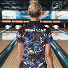 Load image into Gallery viewer, Back view of a female model in a bowling lane wearing a polo shirt with flaming bald eagle, blue bowling ball, American flag, and blue flames.