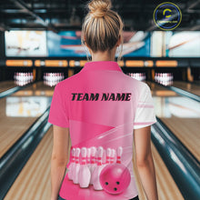 Load image into Gallery viewer, Back view of a female model in a bowling lane wearing a bowling polo shirt with bowling ball and pins arranged across a pink gradient layout.