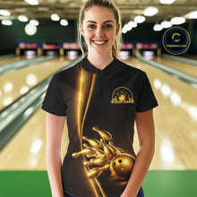 Load image into Gallery viewer, Front view of a female model in a bowling lane wearing a black quarter-zip shirt with golden bowling ball and pins artwork and clean athletic styling.