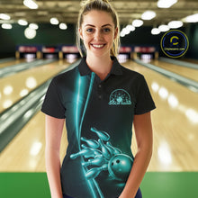 Load image into Gallery viewer, Front view of a female model in a bowling lane wearing a black polo shirt with turquoise blue bowling ball and pins design and dynamic bowling visuals.