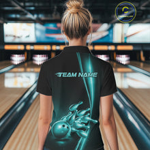Load image into Gallery viewer, Back view of a female model in a bowling lane wearing a black polo shirt featuring turquoise blue bowling ball and pins artwork with athletic sports styling.