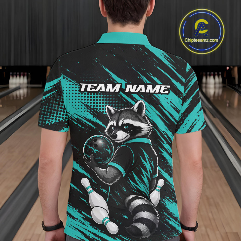 A person standing in a bowling alley wearing a short-sleeve collared shirt shown from the back. The shirt has a black and teal graphic design with a raccoon holding a bowling ball and pins, plus the text 'TEAM NAME' across the upper back.
