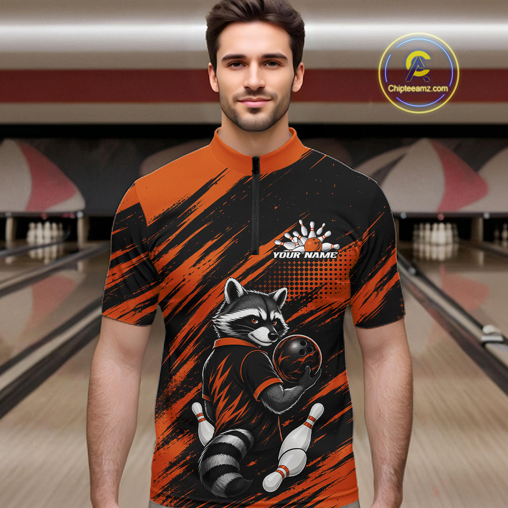 A man wearing a short-sleeve quarter-zip bowling jersey with a raccoon graphic and orange/black brushstroke pattern, set against a bowling alley background. A 'Chipreamz.