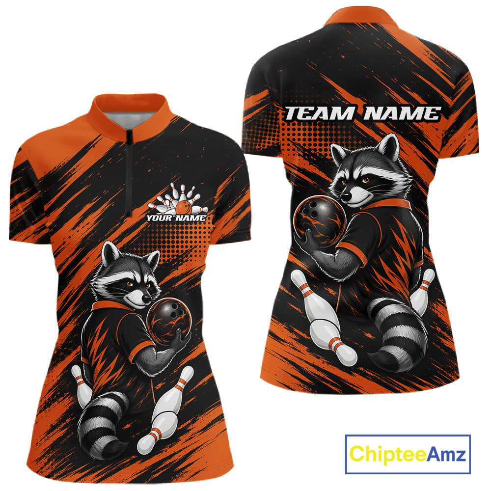 Front and back views of a women's short-sleeve quarter-zip athletic shirt in black and orange, featuring a raccoon graphic holding bowling balls and pins, with 'TEAM NAME' and 'YOUR NAME' placeholder text on the chest and back.