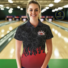 Load image into Gallery viewer, Front view of a female model in a bowling lane wearing a black polo shirt with vibrant red flames and bowling ball pattern and dynamic flaming bowling design.