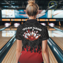 Load image into Gallery viewer, Back view of a female model in a bowling lane wearing a black polo shirt featuring bowling ball pattern with vibrant red flames rising from the bottom and dynamic flaming bowling graphics.