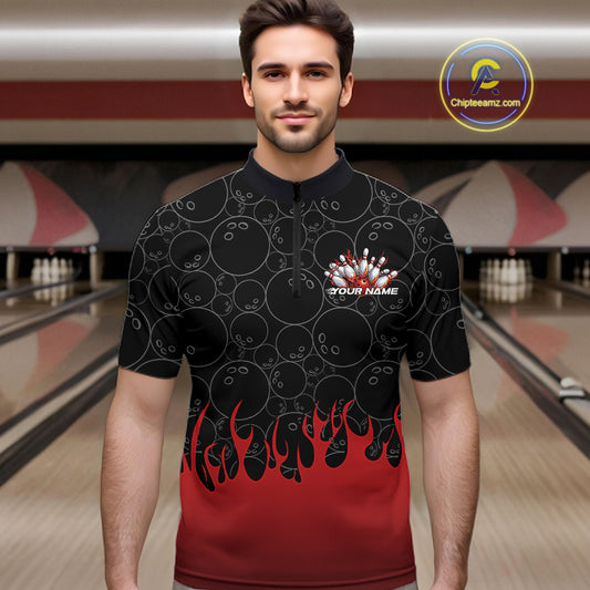 Male model at a bowling lane wearing a black quarter zip shirt, front view showing bowling ball pattern with red flames rising and energetic bowling-themed illustration