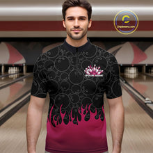 Load image into Gallery viewer, Male model in a bowling alley wearing a black quarter zip shirt, front view featuring bowling ball pattern with vibrant pink flames rising from the bottom and flaming bowling-themed graphics
