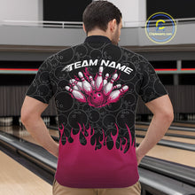 Load image into Gallery viewer, Male model in a bowling lane wearing a black quarter zip shirt, front view showcasing bowling ball pattern with pink flames rising and dynamic bowling action artwork