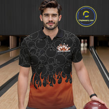 Load image into Gallery viewer, Front view of a male model in a bowling lane wearing a black polo shirt with vibrant orange flames and bowling ball pattern with flaming bowling action design.