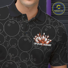 Load image into Gallery viewer, Close-up view of the left chest of a black bowling polo shirt showing bowling ball pattern with vibrant orange flames rising and detailed sporty graphics.
