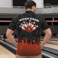 Load image into Gallery viewer, Male model in a bowling lane wearing black quarter zip shirt, front view featuring orange flames rising with bowling ball pattern and energetic sports design