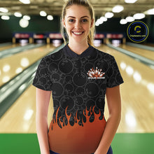 Load image into Gallery viewer, In a bowling lane, front view of a female model wearing a black bowling quarter-zip shirt with vibrant orange flames, featuring flaming bowling ball striking pins illustration.