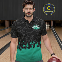 Load image into Gallery viewer, Front view of a male model in a bowling lane wearing a black polo shirt with turquoise green flames and dynamic bowling ball pattern design.