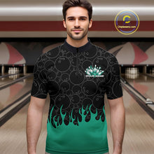 Load image into Gallery viewer, Male model in a bowling lane wearing black quarter zip shirt, front view showcasing bowling ball pattern with turquoise green flames and dynamic bowling artwork