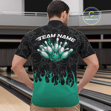 Load image into Gallery viewer, Male model in a bowling lane wearing black quarter zip shirt, front view showcasing bowling ball pattern with turquoise green flames and dynamic bowling artwork