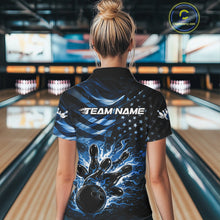 Load image into Gallery viewer, Back view of a female model in a black bowling polo shirt showcasing blue flame bowling strike artwork and distressed flag motifs.