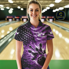 Load image into Gallery viewer, Female model wearing a black bowling polo shirt at the bowling lane with purple flame bowling graphics and patriotic-themed artwork.