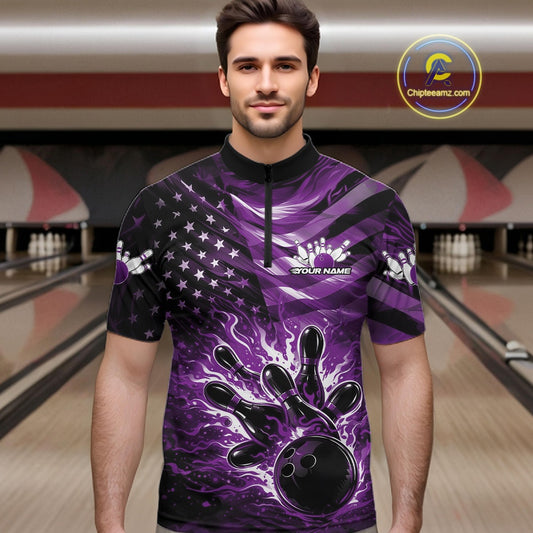 Male model wearing a black bowling quarter-zip shirt at the lane with purple flame bowling artwork and flag-inspired accents.