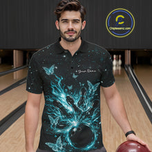 Load image into Gallery viewer, Male model wearing a black and turquoise blue bowling polo shirt at the lane with cosmic bowling strike artwork and luminous butterflies.