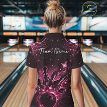 Load image into Gallery viewer, Back view of a female model wearing a black and pink bowling polo shirt with glowing butterfly accents.