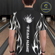 Load image into Gallery viewer, Male model seen from the back in a bowling lane wearing a black polo shirt featuring a silver metal tribal flame bowling ball striking pins in a dynamic motion design.