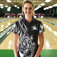 Load image into Gallery viewer, Female model front view in a bowling lane wearing a black polo shirt with a silver metal tribal flame bowling ball striking pins in an intense sports action scene.