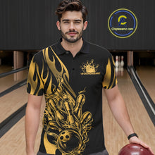 Load image into Gallery viewer, Male model seen from the front in a bowling lane wearing a black polo shirt featuring a golden metal tribal flame bowling ball striking pins in a dynamic action scene.