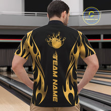 Load image into Gallery viewer, Front view male model at bowling lane wearing black quarter zip featuring golden tribal flame accents with bowling ball hitting pins in dynamic motion scene.