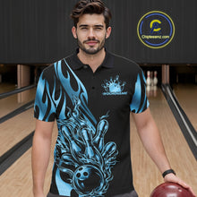 Load image into Gallery viewer, Male model seen from the front in a bowling lane wearing a black polo shirt featuring a blue gradient tribal flame bowling ball striking pins in a dynamic sports action scene.