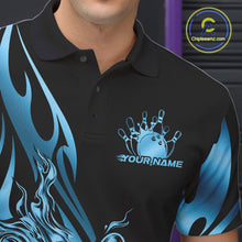 Load image into Gallery viewer, Close-up view of the left chest area of a black polo shirt showing a blue gradient tribal flame bowling ball and pins design detail.