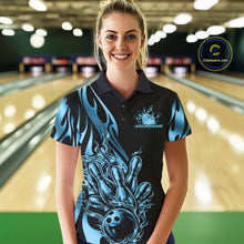 Load image into Gallery viewer, Female model seen from the front in a bowling lane wearing a black polo shirt featuring a blue gradient tribal flame design with a bowling ball striking pins in dynamic motion.