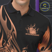 Load image into Gallery viewer, Close-up view of the left chest area of a black polo shirt showing a rose gold gradient tribal flame bowling ball and pins design detail.